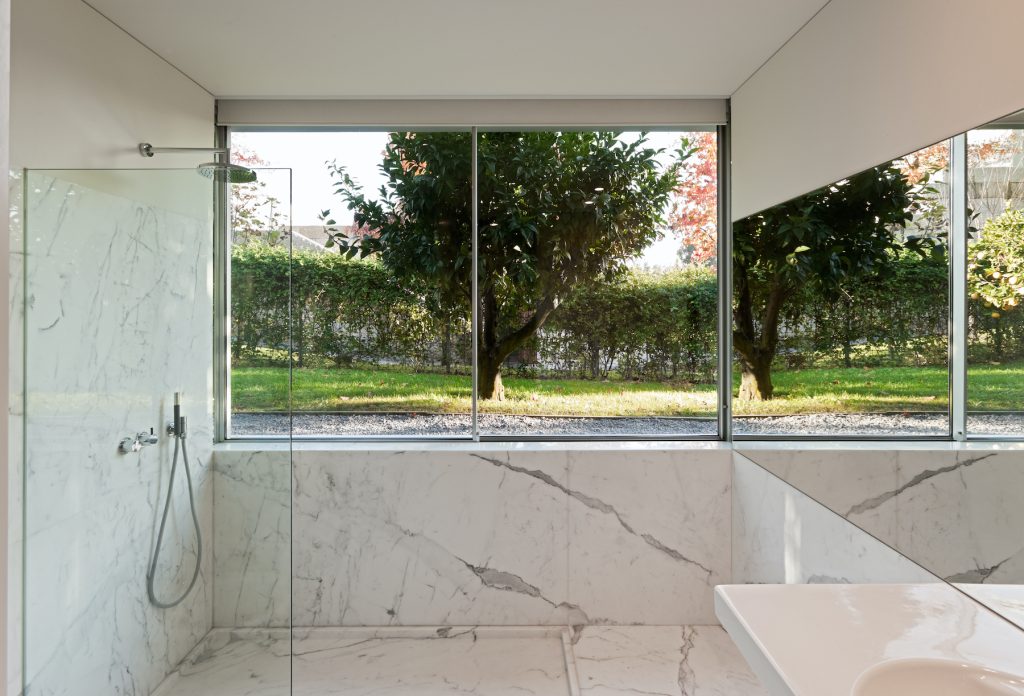 Image of a bathroom with white marble floor and walls